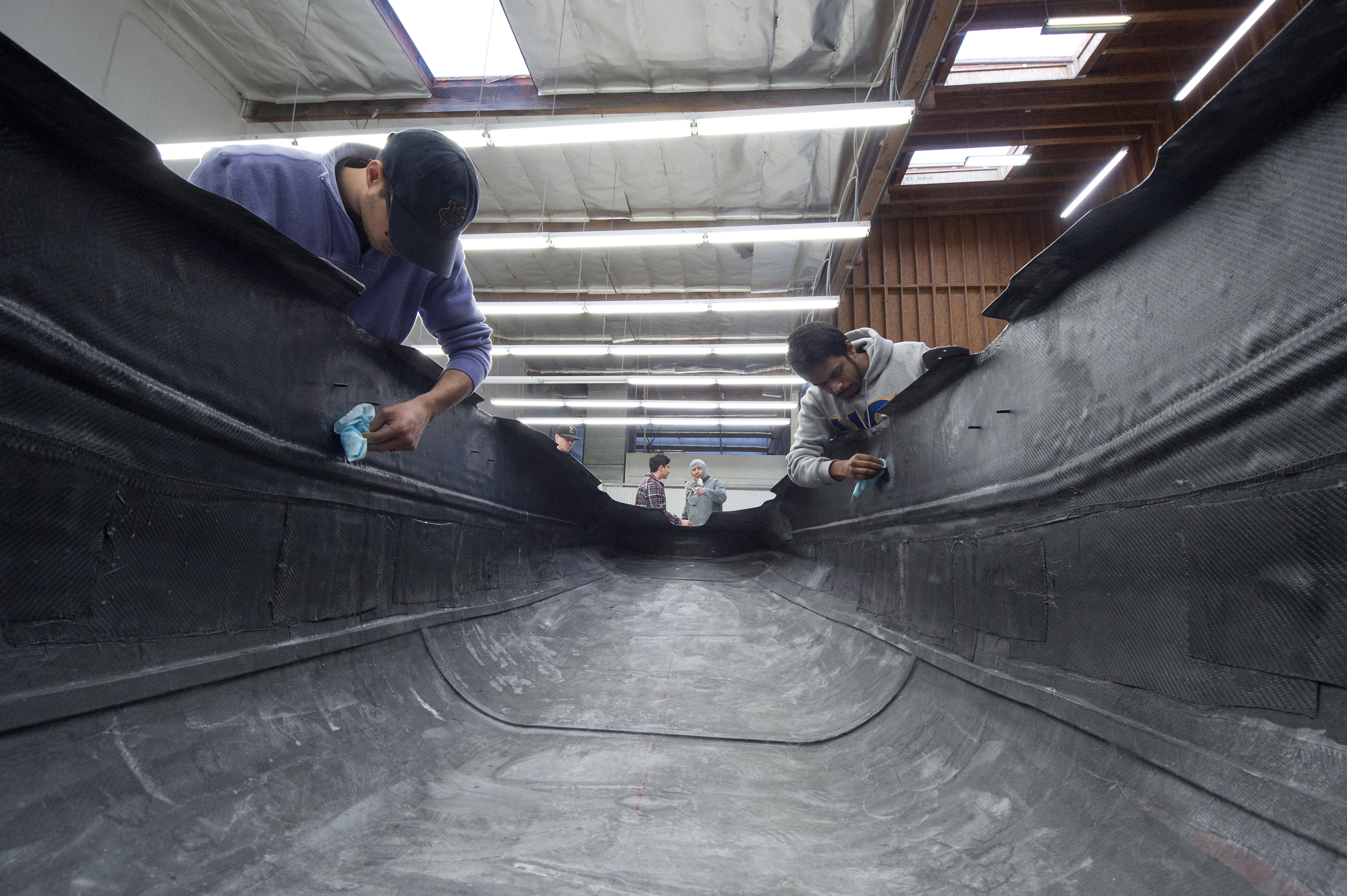 Mechanical engineering major Anthony Long (left) and aerospace engineering major Arjuna Rathnayake work on the pods carbon fiber shell at ADM Works in Santa Ana.

Steve Zylius / UCI